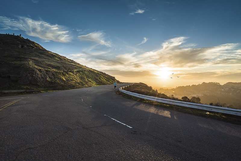 Runner on a hill during sunset.